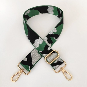 Close-up of green camo wide bag strap with gold metal lobster clasps and buckle