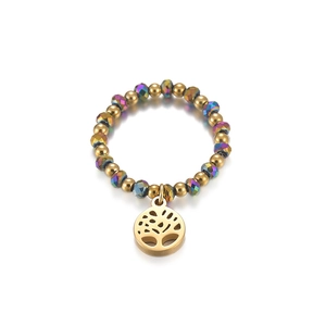 Close-up of beaded elastic ring with Tree of Life charm and colorful crystal beads