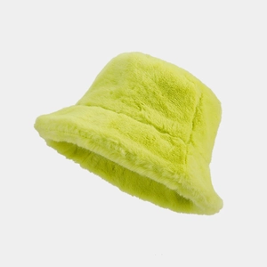 Detailed texture of fluffy neon green faux fur bucket hat with soft plush finish