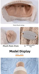 Detail view of thickened plush lining and fluffy pompom on the beige winter knitted hat