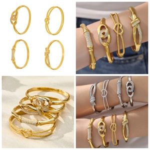 Detailed view of 18k gold plated stainless steel bangles with heart and zircon accents