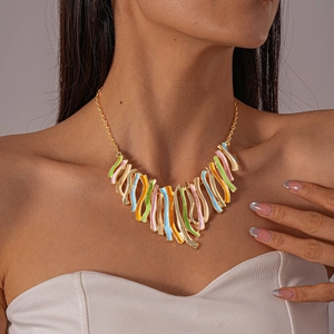 Close-up of wavy enamel fringe necklace in colorful abstract art style on female model
