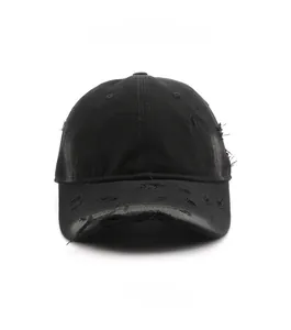Detailed view of black distressed cotton baseball cap with vintage frayed and ripped effects