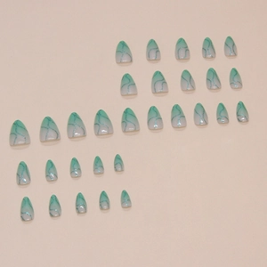 Green gradient almond press-on nails with blue glitter wave patterns on light background