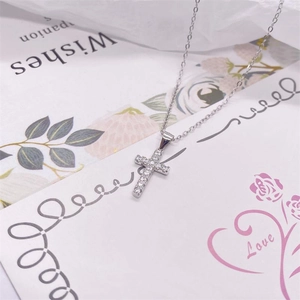 Close-up of S925 sterling silver cross pendant necklace with sparkling white zircons