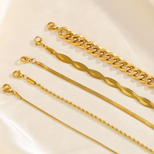 Set of five 18K gold plated stainless steel Cuban and snake chain bracelets on silk