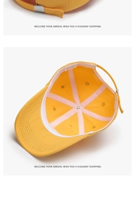 Detail of yellow cotton baseball cap showing internal stitching and metal adjustment buckle