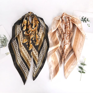 Baroque style satin silk square scarves in black gold and beige gold hanging display