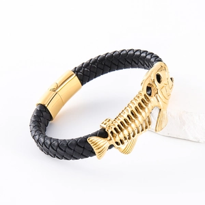 Macro detail of men's black braided leather bracelet with golden steel fishbone and magnetic clasp