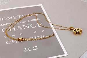 Macro detail of golden Tree of Life cutout pendant necklace with O-chain and lobster clasp