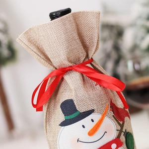 Christmas burlap wine bottle cover featuring snowman embroidery and a red satin ribbon bow
