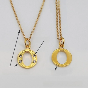 Detail of 18K gold-plated letter O pendant necklace with sparkling inset rhinestones