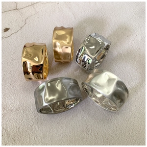 Detailed view of 5-piece chunky metal rings set with unique irregular hammered textures