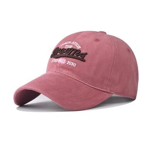 Detail of 3D embroidery on dusty rose vintage washed cotton baseball cap with text
