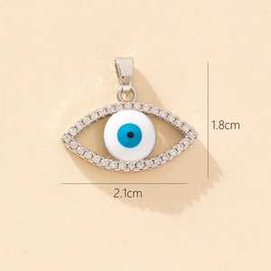 Detail view of silver evil eye pendant with blue enamel and clear stones 21mm x 18mm size