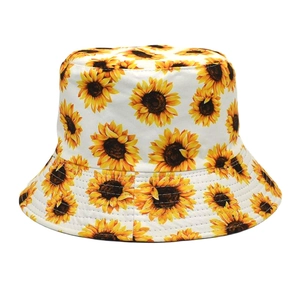 Detailed view of vibrant sunflower prints on a white cotton canvas bucket hat fabric