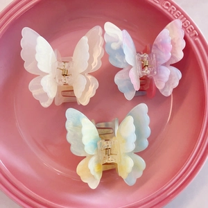 Three-piece set of 3D layered butterfly hair claws in cream, pink, and blue iridescent colors