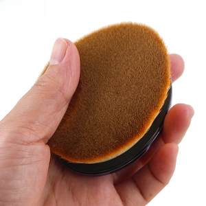 Macro detail of high-density synthetic fiber bristles on an ergonomic foundation brush