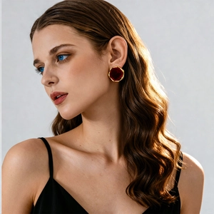 Close-up of a model wearing a vintage red flocking round stud earring with gold base