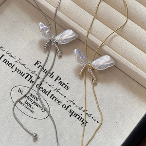 Elegant butterfly necklace with pearls and rhinestones on fine silver and gold chain