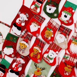 Flat lay of colorful Christmas stockings with Santa, snowman, and reindeer 3D character designs