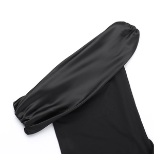 Detail of elegant black satin fabric showing smooth texture and pleated design elements