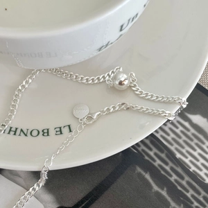 Minimalist S925 sterling silver beaded chain necklace with mini round pendant on a plate