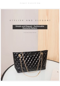 Close-up of black quilted shoulder bag featuring gold chain strap and glossy finish