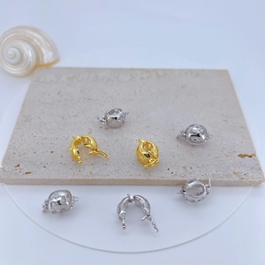 Detailed macro view of gold and silver plated copper pendants with cubic zirconia inlay