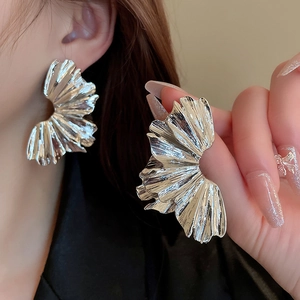 Exaggerated silver fan-shaped pleated metal earrings with minimalist geometric design