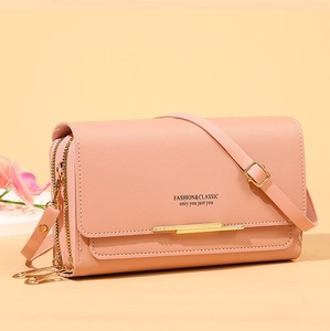 Side view of pink crossbody cell phone wallet with gold zippers and metal hardware