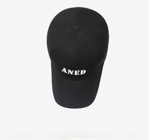 Top down view of black baseball cap with white embroidered ANED lettering and classic panels