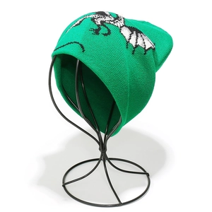 Detail of green knit beanie featuring high-quality woven bone patterns and thick texture