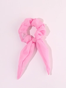Close-up of pink LED scrunchie with bow made of sheer tulle fabric for Christmas