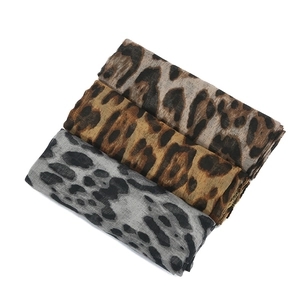 Lightweight leopard print scarves in brown and grey tones on a clean white background