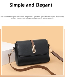 Detail of black pebbled leather texture and gold rectangular buckle on minimalist bag