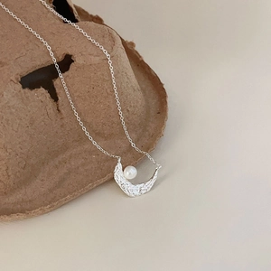 Elegant 925 sterling silver necklace with textured crescent moon pendant and white pearl