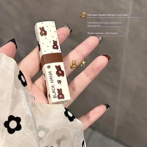 Matte velvet lip clay in bear-themed tube with brand logo held in hand