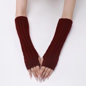Close-up of cable knit texture on burgundy winter arm warmers showing stitching details