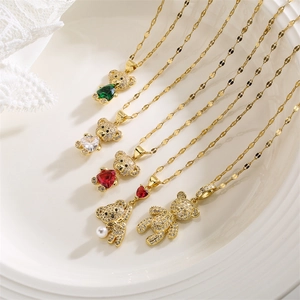 Detail of five cute gold teddy bear necklaces with colorful heart stones and micro zircons