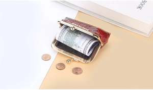 Detail of red crocodile texture coin purse with vintage gold metal clasp closure