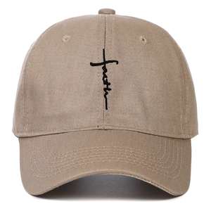 Detailed embroidery of the Faith cross design on a khaki cotton baseball cap crown