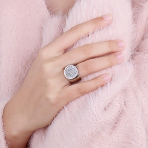 Close-up of a silver-toned wide band ring featuring a detailed Hamsa Hand engraving