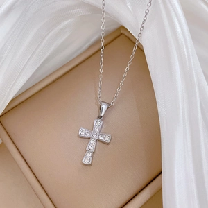 Detail shot of a silver titanium steel cross pendant necklace with sparkling rhinestones