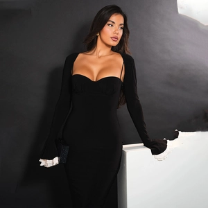 Detail of elegant black slim-fit dress featuring white ruffled cuffs and long sleeves