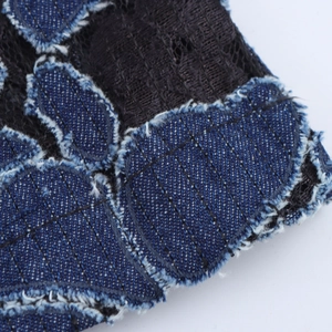 Women's vintage blue denim straight pants featuring intricate black lace embroidery detail