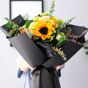 Sunflower and rose bouquet wrapped in black embossed dotted waterproof flower paper