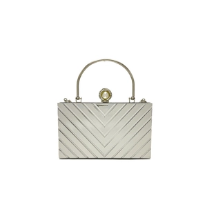 Detailed view of silver acrylic evening clutch featuring V-shape pattern and pearl clasp