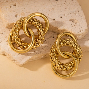 Chic 18K gold plated stainless steel interlocking hoop earrings on beige stone stand