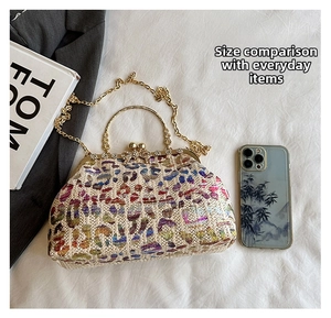 Detailed size comparison of multi-color straw clutch bag with a mobile phone